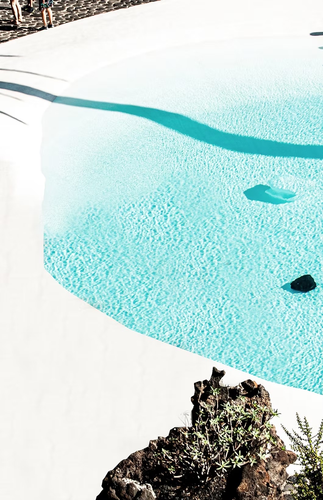 Turquoise pool beside volcanic rock, Algarve