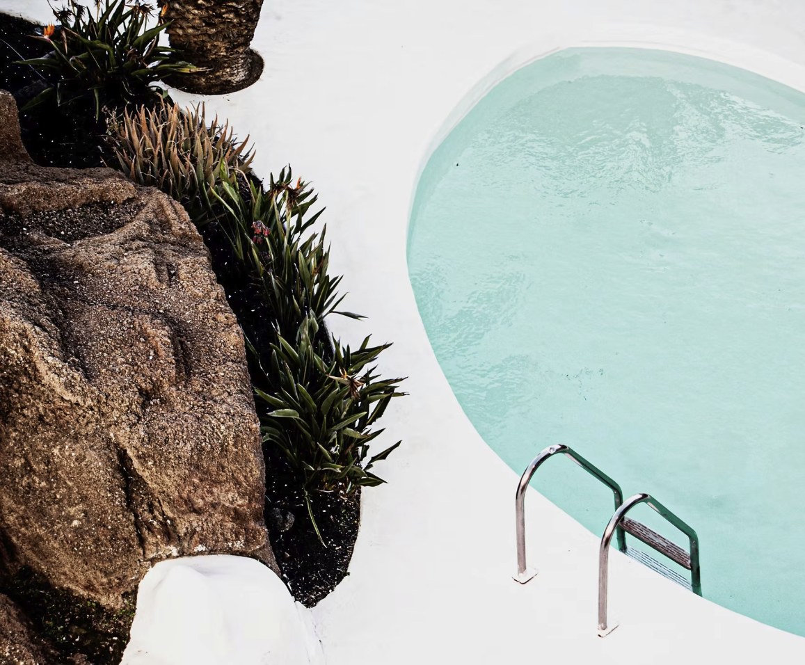 Rock formation beside a turquoise pool