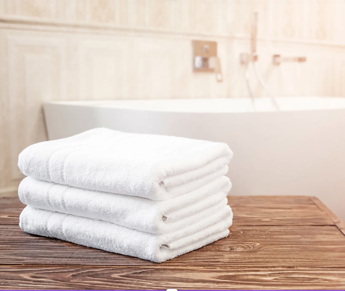 Folded towels on a wooden surface