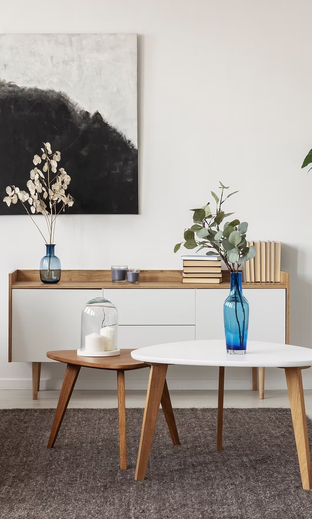 White nesting tables with blue glass vase